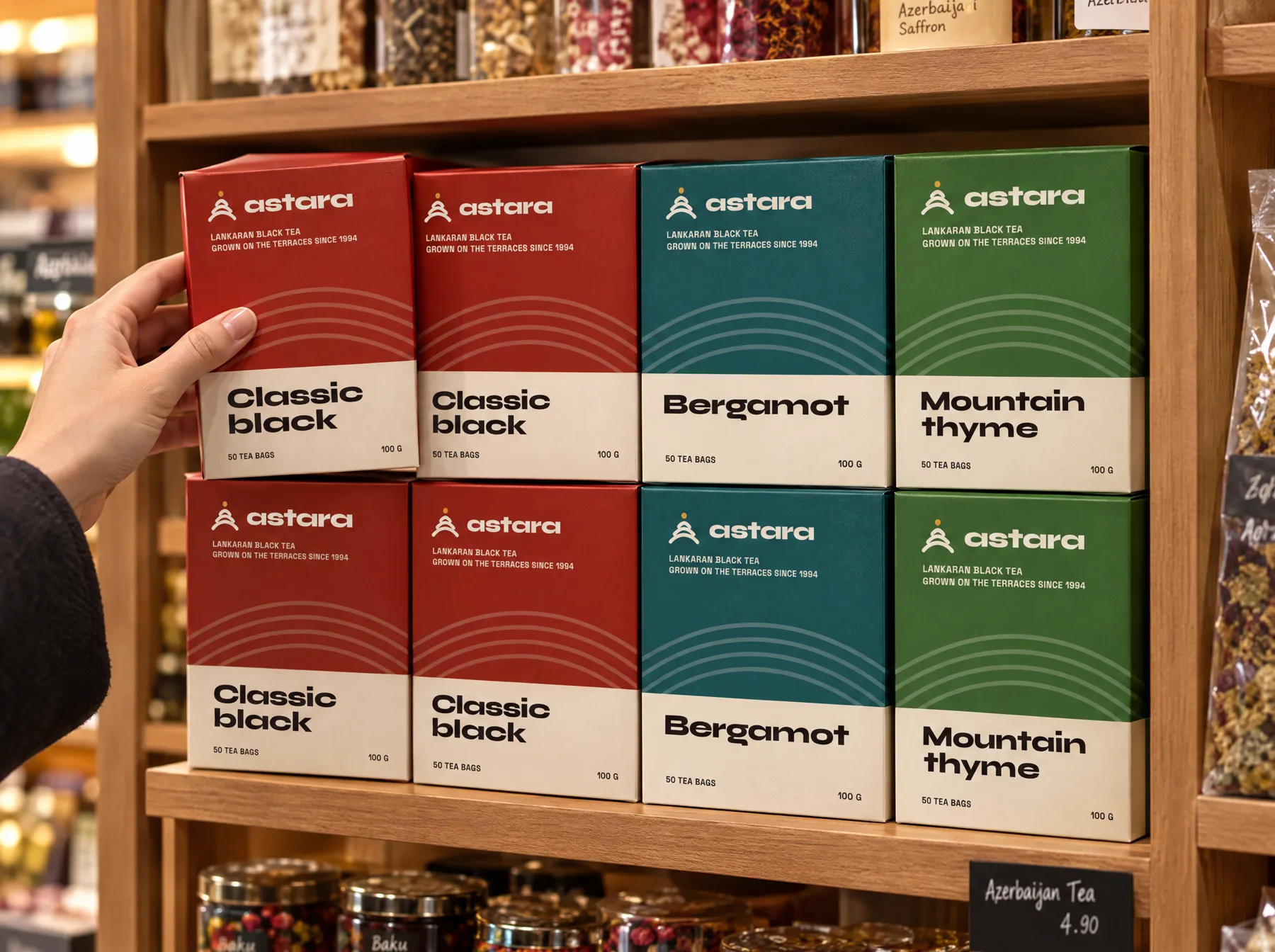 Astara tea cartons in red, teal and green on a wooden shop shelf
